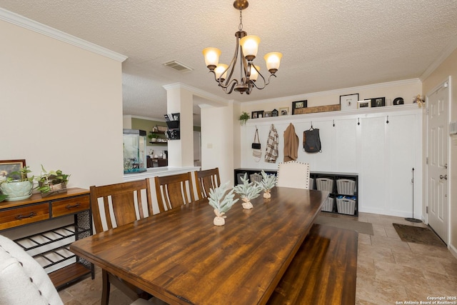 dining area featuring a chandelier, a textured ceiling, and crown molding