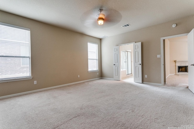 carpeted spare room with ceiling fan