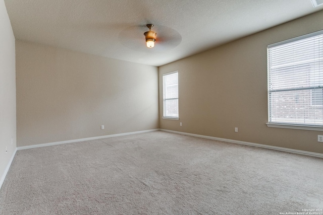 unfurnished room featuring light colored carpet and ceiling fan