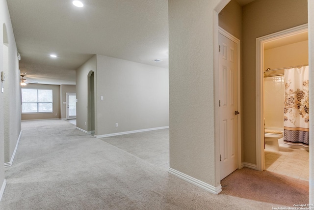 hallway with light colored carpet