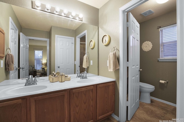 bathroom with vanity and toilet