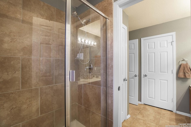 bathroom featuring tile patterned floors and a shower with door