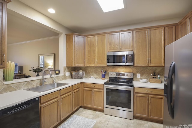 kitchen with crown molding, decorative backsplash, sink, and stainless steel appliances