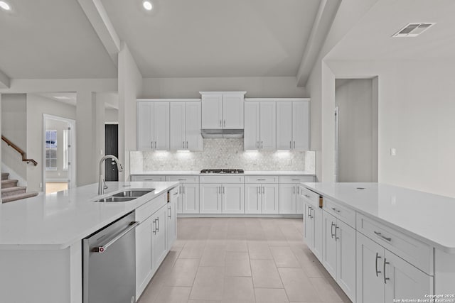 kitchen with white cabinetry, dishwasher, sink, and a center island with sink