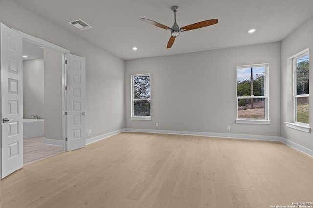 empty room featuring ceiling fan and light hardwood / wood-style floors