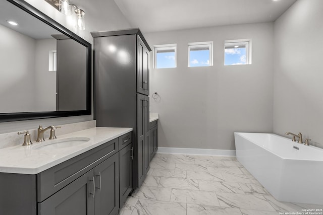 bathroom with vanity and a bath