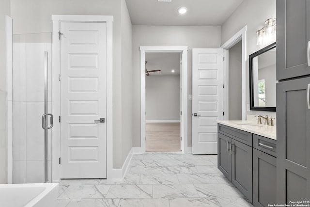 bathroom featuring ceiling fan, vanity, and an enclosed shower