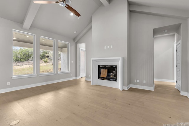 unfurnished living room with ceiling fan, beam ceiling, high vaulted ceiling, and light wood-type flooring