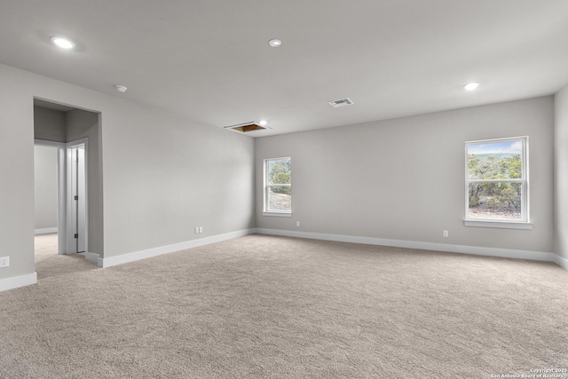 carpeted spare room featuring a wealth of natural light