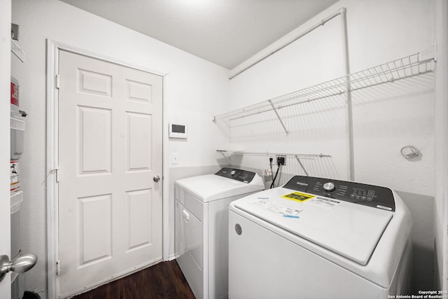 washroom with washing machine and dryer and dark wood-type flooring