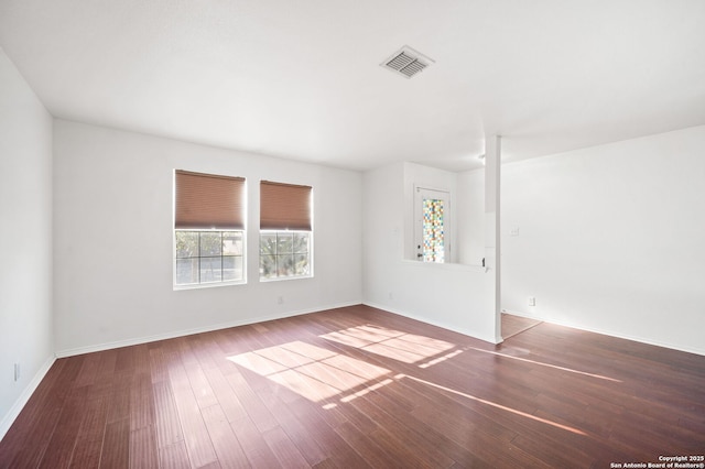 spare room featuring wood-type flooring