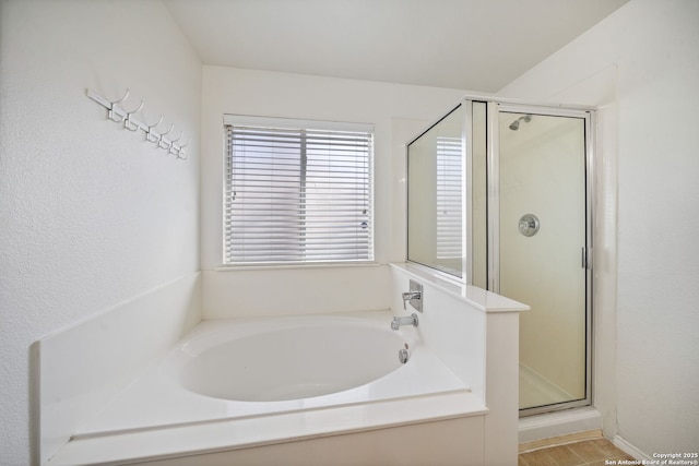 bathroom featuring independent shower and bath