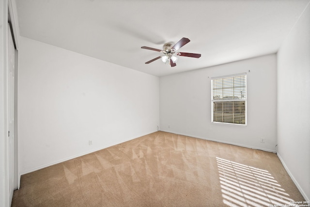 empty room with ceiling fan and light colored carpet