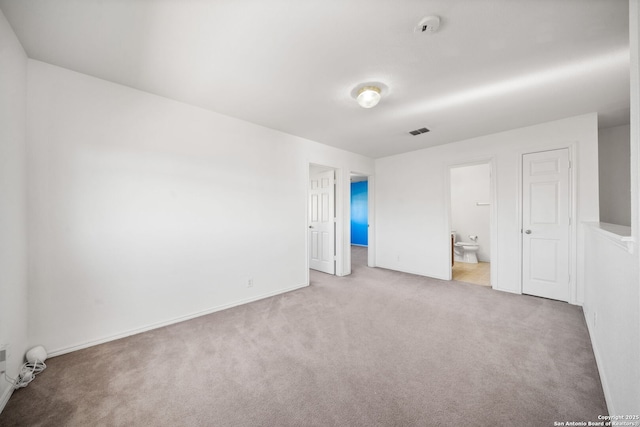 unfurnished bedroom featuring carpet and ensuite bath