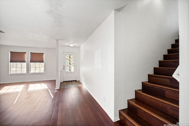 entryway with dark hardwood / wood-style floors