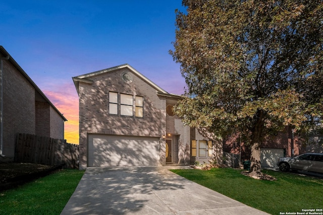 front of property featuring a yard and a garage