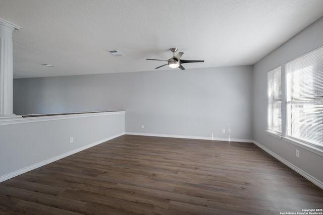 empty room featuring dark hardwood / wood-style flooring and ceiling fan