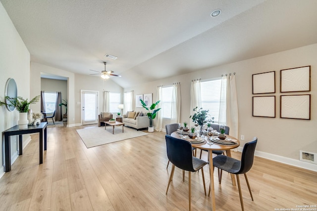 dining area with ceiling fan, light wood-type flooring, and lofted ceiling