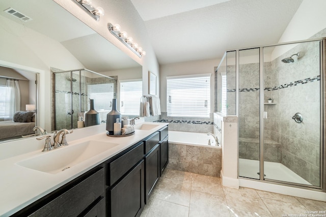 bathroom featuring tile patterned flooring, vanity, vaulted ceiling, and shower with separate bathtub