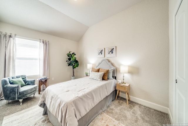 bedroom with a closet, light colored carpet, and lofted ceiling