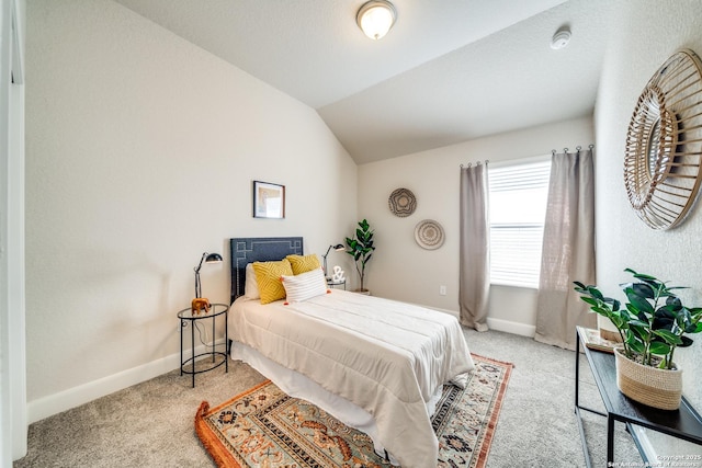 carpeted bedroom featuring lofted ceiling