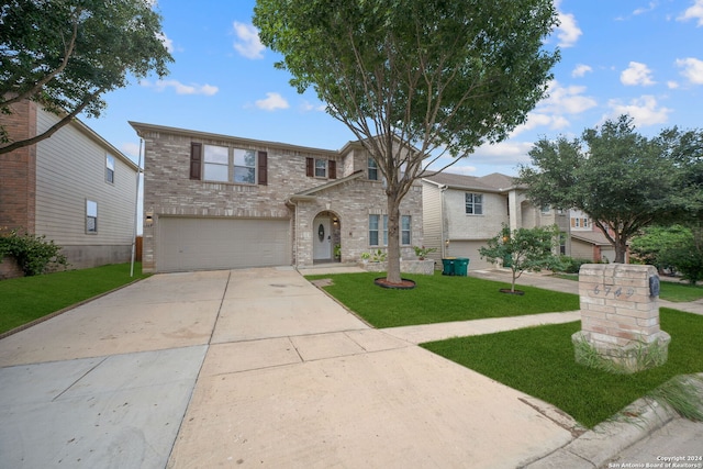 view of front of home with a garage and a front lawn