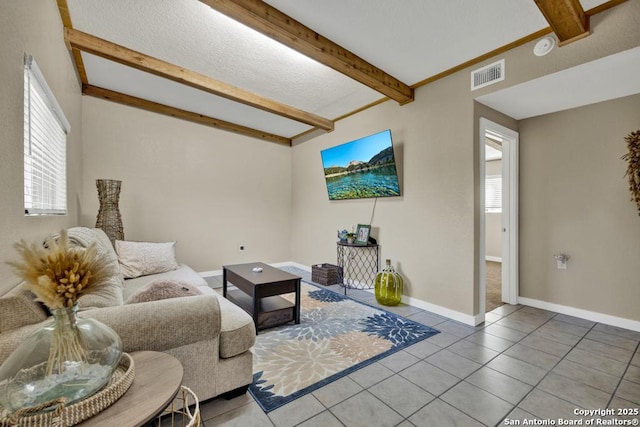 living room with tile patterned floors and beam ceiling