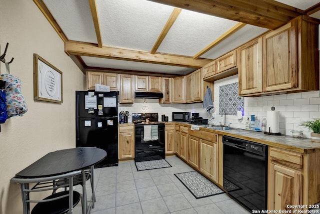 kitchen with tasteful backsplash, a textured ceiling, sink, black appliances, and light tile patterned floors