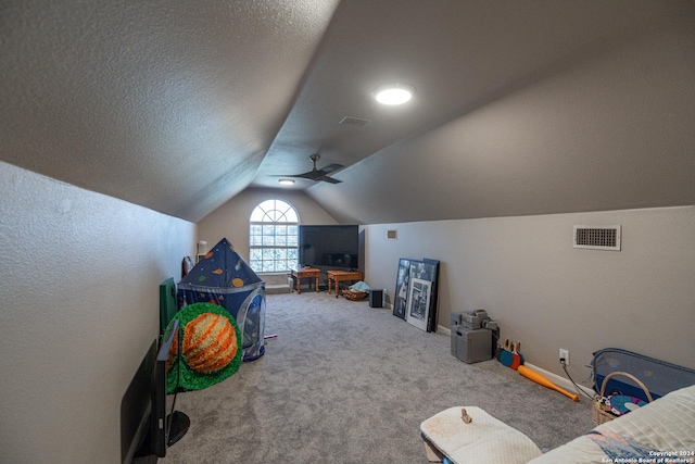 rec room featuring carpet, a textured ceiling, ceiling fan, and lofted ceiling