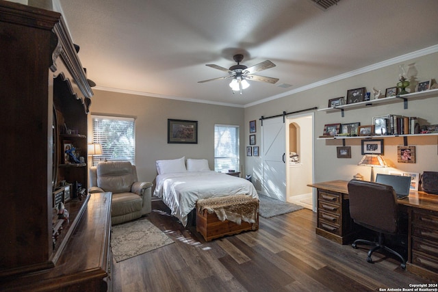 bedroom with a barn door, dark hardwood / wood-style floors, ceiling fan, and crown molding