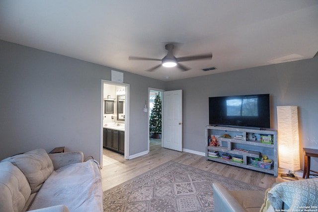 living room with ceiling fan and light wood-type flooring