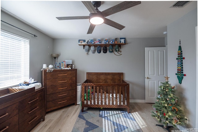 bedroom with ceiling fan and light hardwood / wood-style flooring