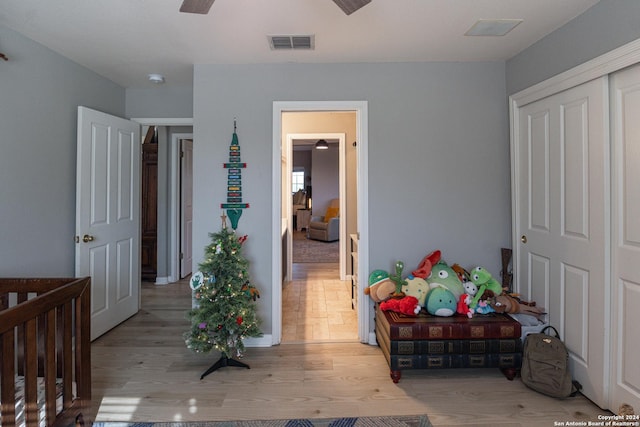 bedroom featuring ceiling fan, a closet, and light hardwood / wood-style floors