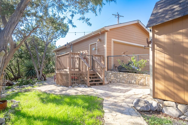 rear view of house featuring a wooden deck