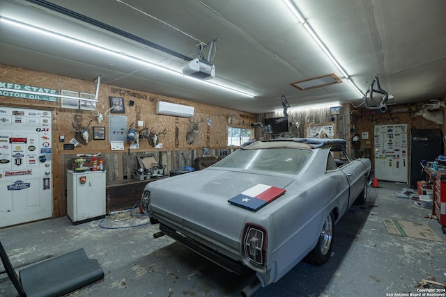 garage with a garage door opener and a wall mounted AC