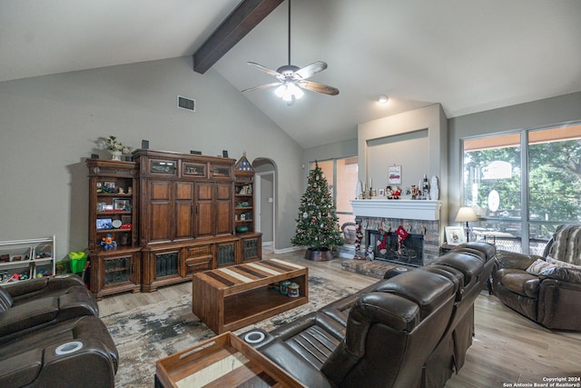 living room featuring beam ceiling, ceiling fan, light hardwood / wood-style flooring, and high vaulted ceiling