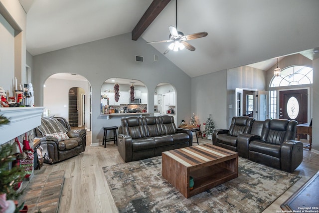 living room with beam ceiling, high vaulted ceiling, light hardwood / wood-style flooring, and ceiling fan