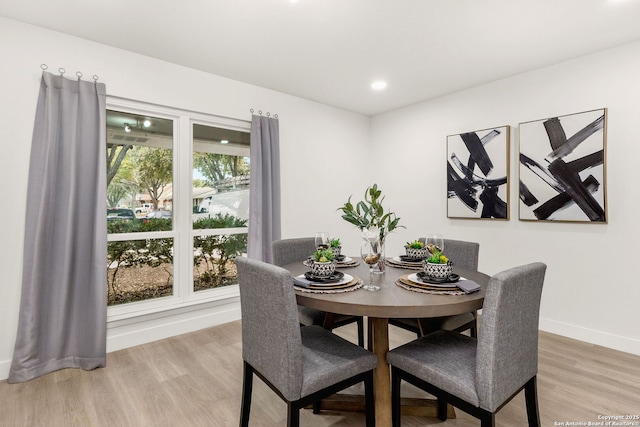 dining space featuring wood-type flooring