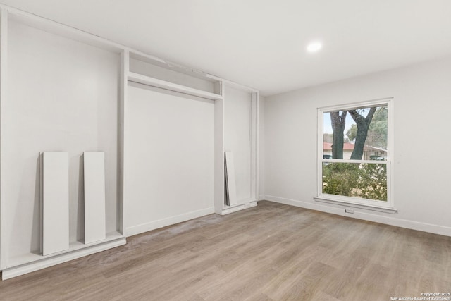 unfurnished bedroom with light hardwood / wood-style floors and a closet