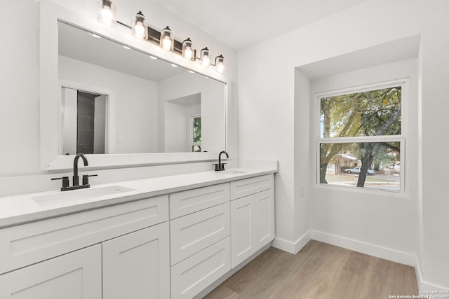 bathroom with vanity and hardwood / wood-style flooring