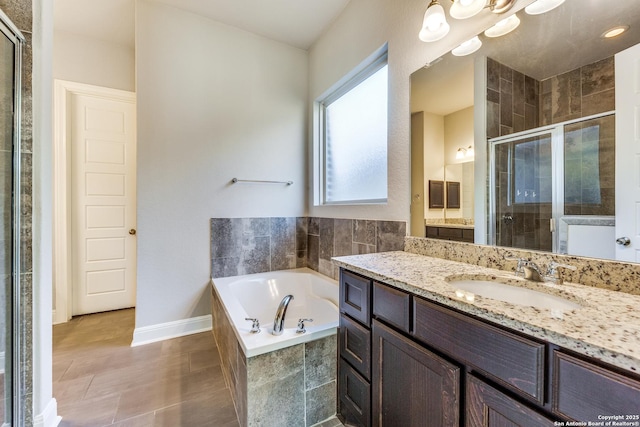 bathroom featuring tile patterned flooring, vanity, and independent shower and bath