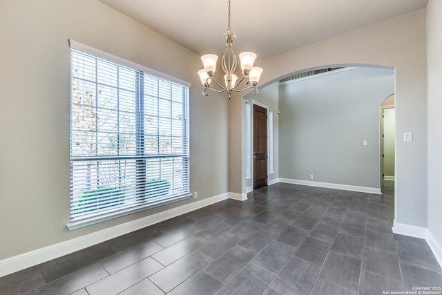 empty room featuring a chandelier