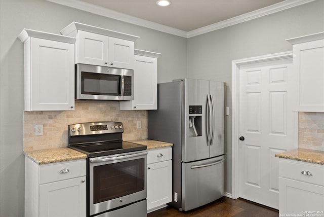 kitchen with white cabinets, decorative backsplash, light stone counters, and stainless steel appliances