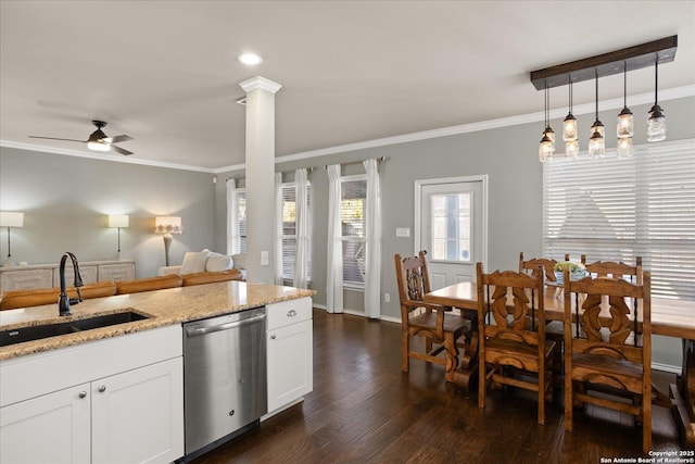 kitchen featuring light stone countertops, white cabinets, sink, dishwasher, and hanging light fixtures