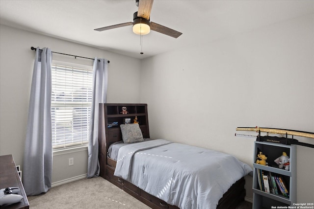 carpeted bedroom featuring ceiling fan and multiple windows