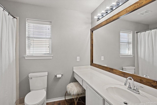 bathroom featuring vanity, hardwood / wood-style flooring, and toilet