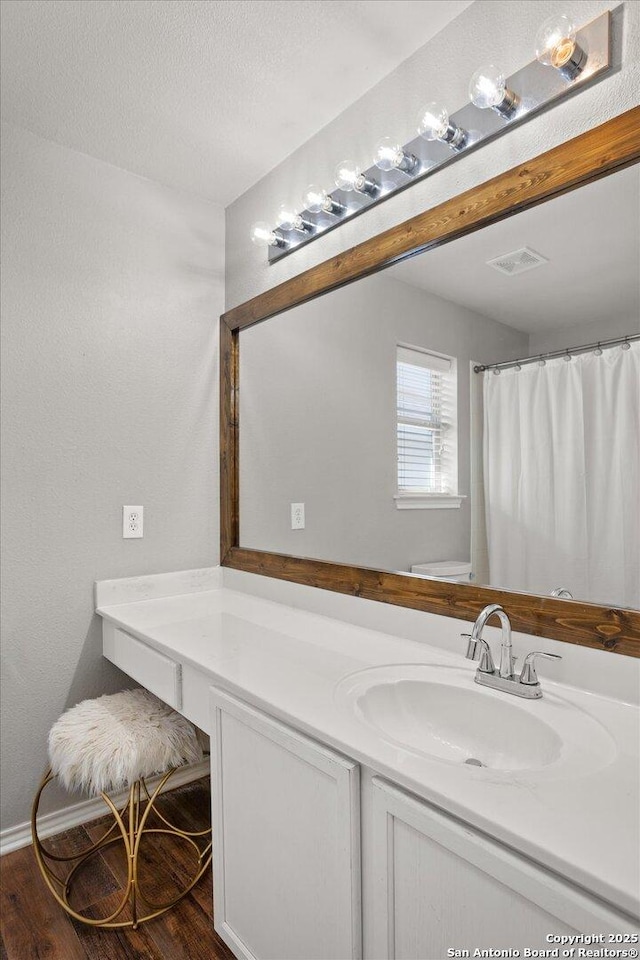 bathroom featuring vanity and hardwood / wood-style flooring