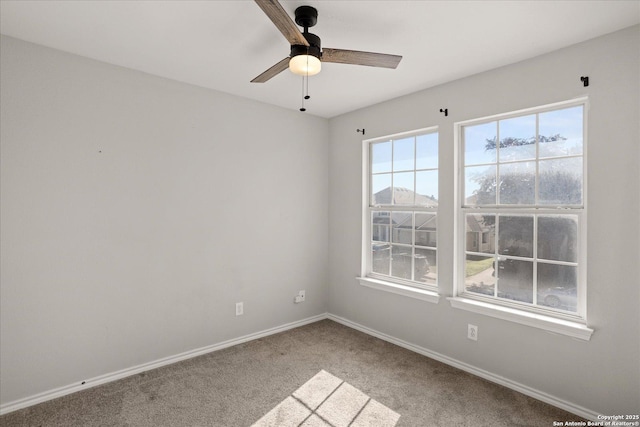 unfurnished room with ceiling fan and carpet floors