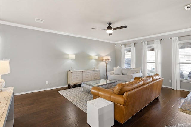 living room with ceiling fan, ornamental molding, and dark wood-type flooring