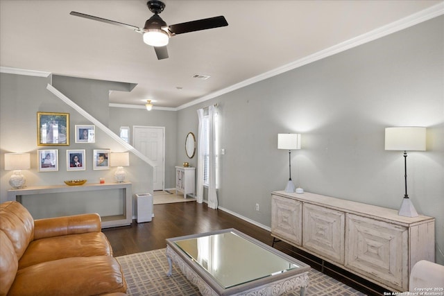 living room with dark hardwood / wood-style floors, ceiling fan, and ornamental molding